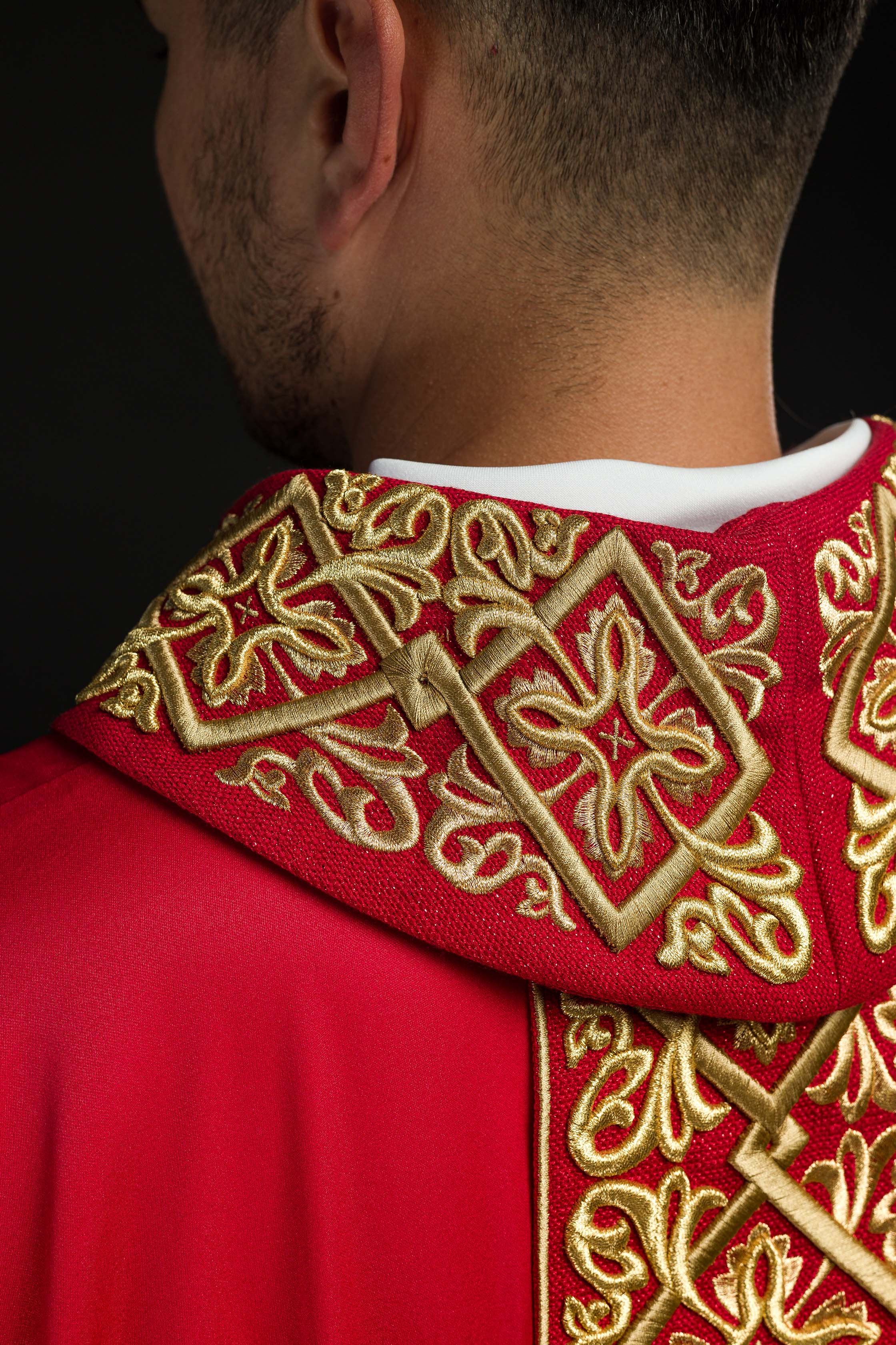 Casulla roja ricamente bordada con motivo floral y cruces