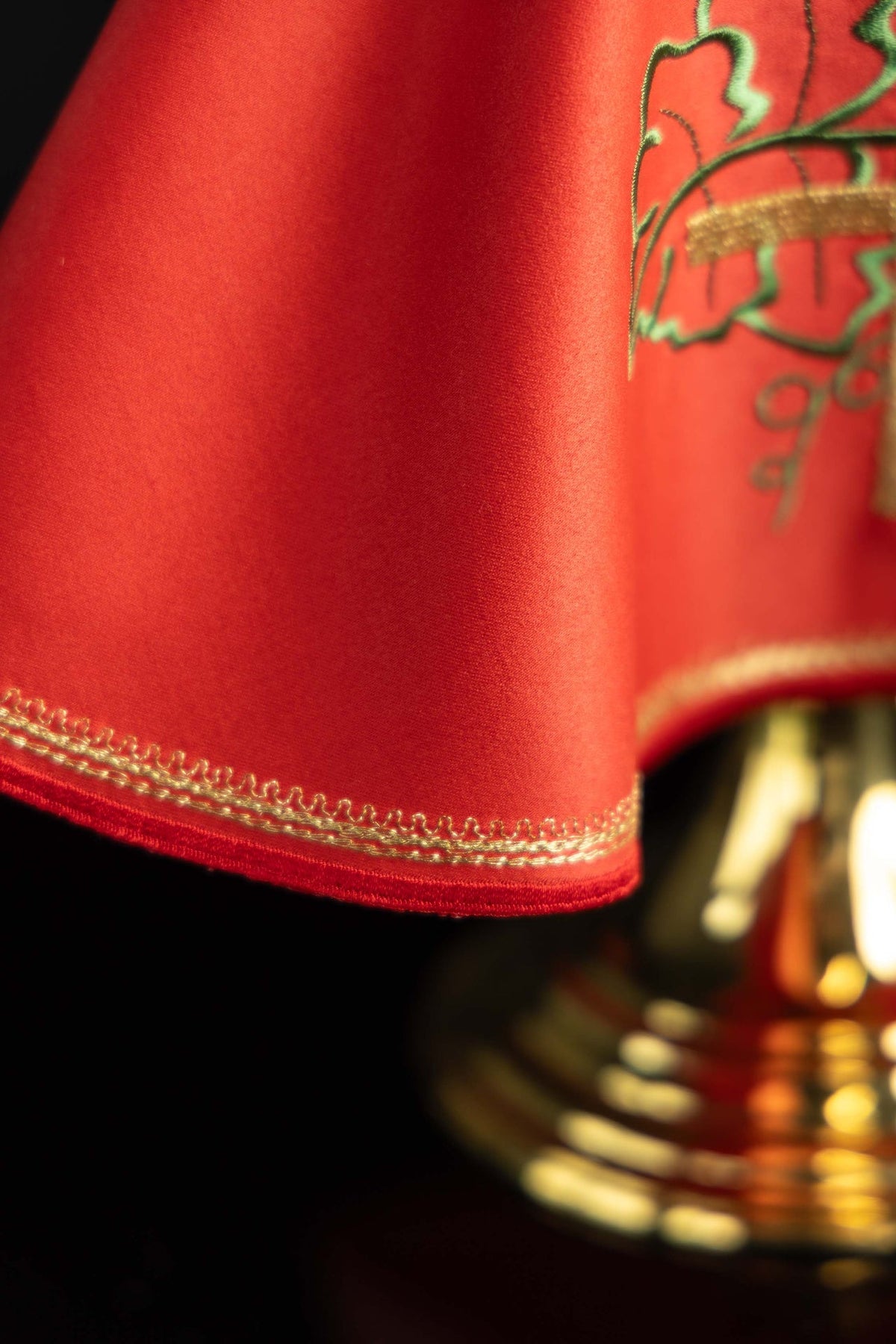 Cubrecopón rojo, detalle del tejido y ribete decorativo dorado